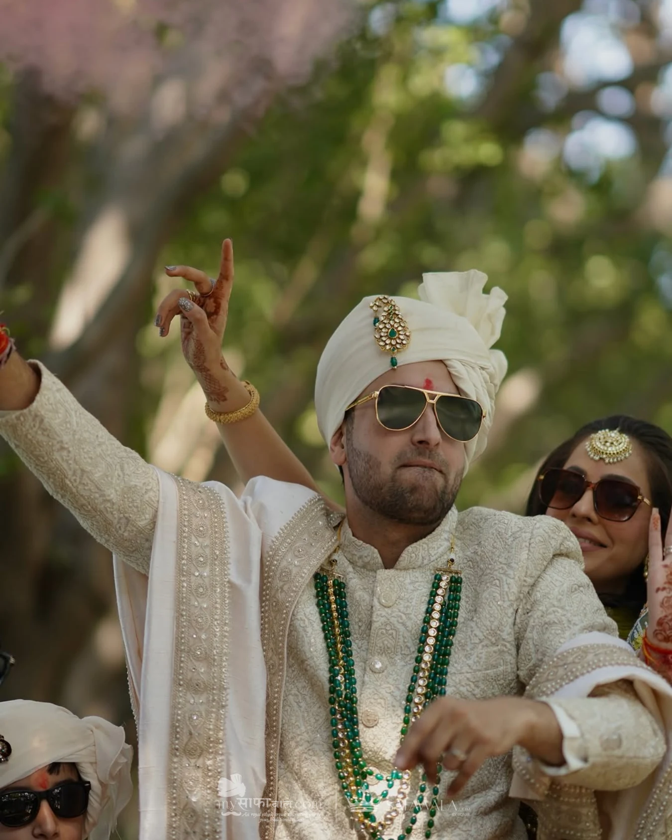Groom in an ivory wedding safa with emerald jewellery for punjabi safa tying in Hanoi